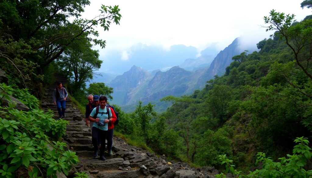 A rugged and challenging mountain trail winds through lush, verdant forests, leading to towering peaks. The foreground depicts hikers navigating steep, rocky switchbacks, their faces etched with determination. In the middle ground, a panoramic view reveals the sheer scale and elevation of the Kumara Parvatha range, with craggy cliffs and sparse vegetation. The background is shrouded in mist, adding an air of mystery and the sense of a daunting, remote location. The lighting is soft and diffused, creating a sense of depth and atmosphere. The overall scene conveys the formidable difficulty and rugged terrain of the Kumara Parvatha Trek.